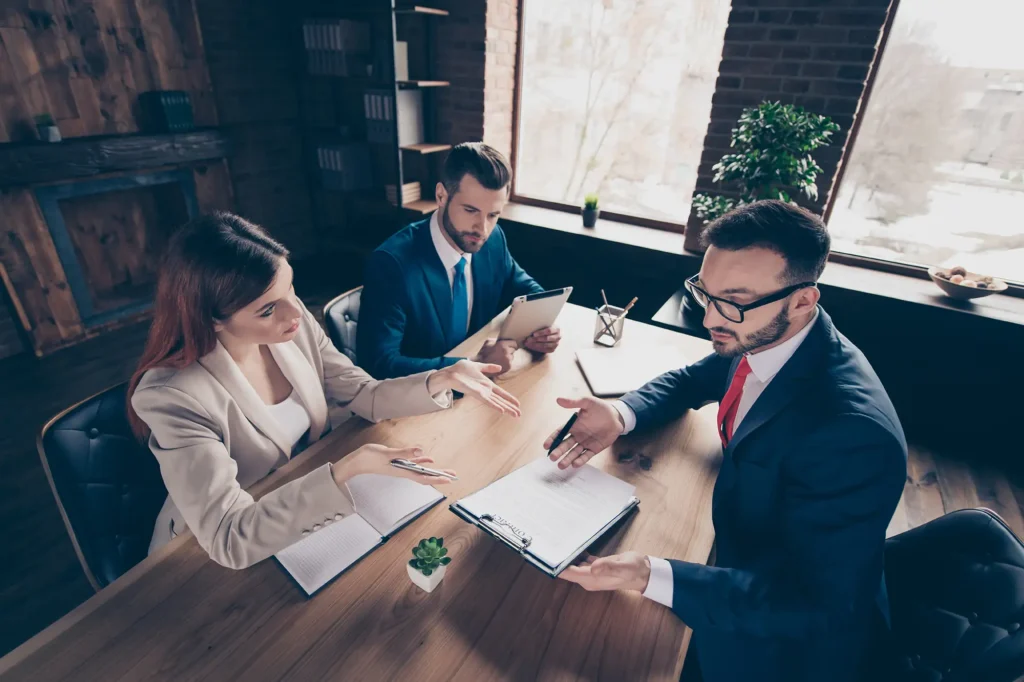 Attorney reviewing a settlement agreement with clients during a premises liability consultation